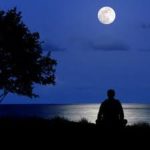 man-meditating-under-moon
